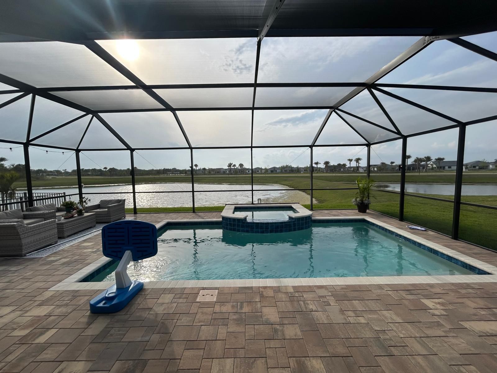 Luxurious poolside patio with a full screen enclosure